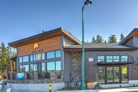 the front of a restaurant with large windows and a street light